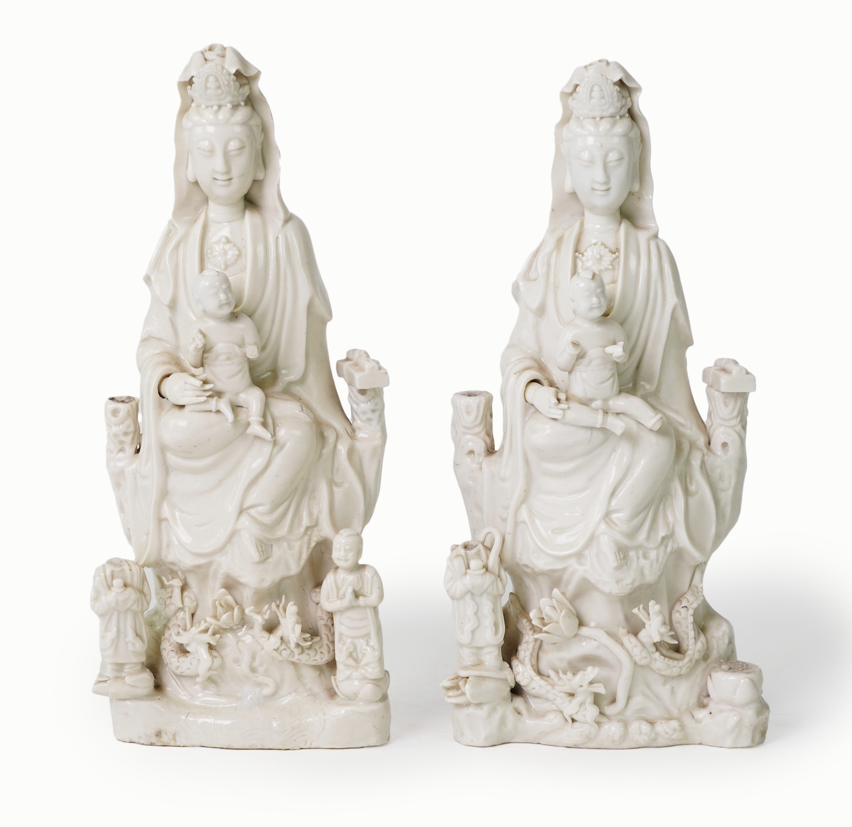 A pair of Chinese blanc de chine groups of Guanyin and children, 18th century